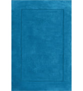 Solid teal hand-tufted wool rug with minimalist border design